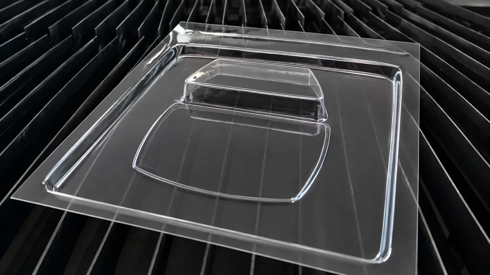 Transparent thermoformed PMMA light diffuser cover for a lighting application.